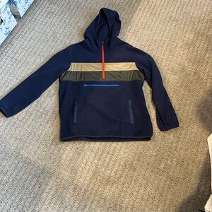 Cotopaxi Navy Blue Pullover with olive and tan accents.
